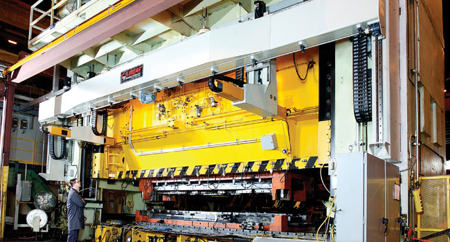 An image of a Window Mounted Linear Automation transfer system on a large, white press.