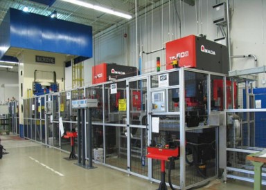 Linear Automation turn-key line linking multiple presses together, forming solar panel parts..