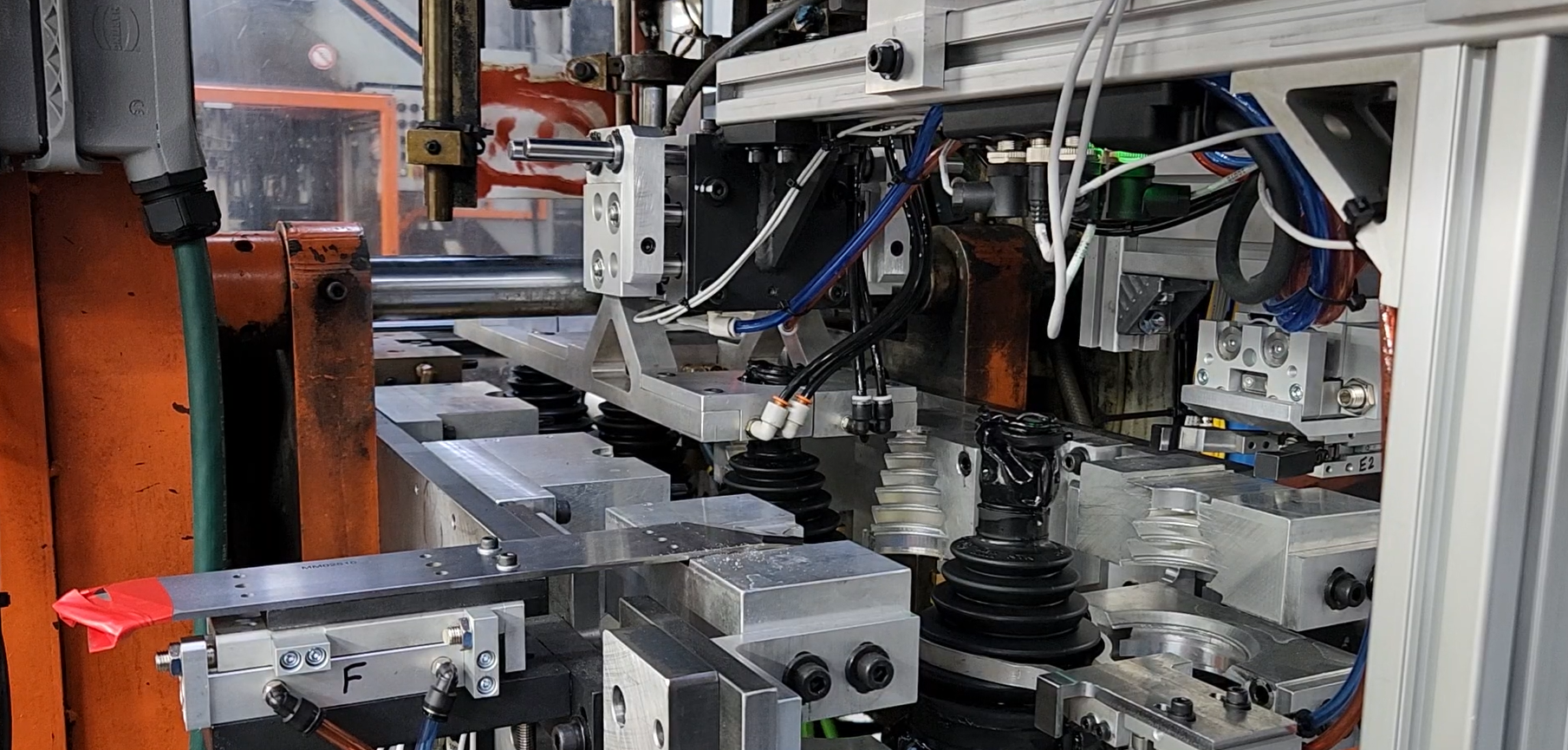 An image of a Linear Automation system that trims and moves rubber through a specialized machine.
